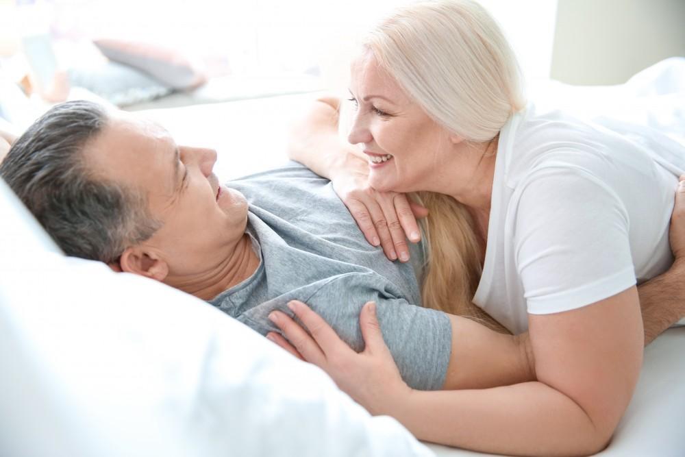 happy husband and wife on the bed